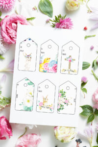 This image shows the 6 free pretty printable Easter gift tags you can download at the end of this post. They are in in a traditional pale color scheme. Each design is different - there are Easter bunny rabbits, a cross, a chick, and lots of florals. The tags are surrounded by flowers.