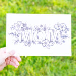 This is the picture of one of the free printable Mother's Day cards to color. This card says Mom and the word is surrounded by flowers and greenery.