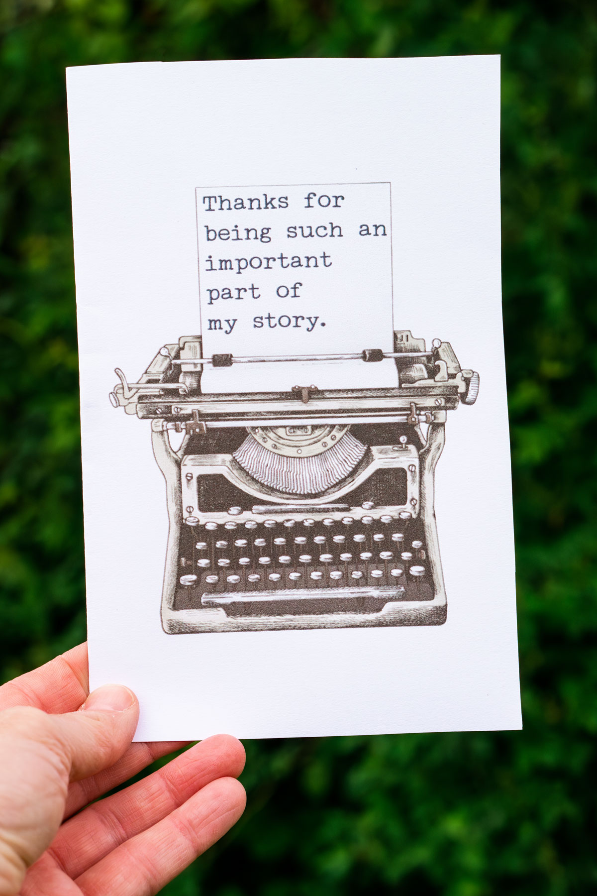 This image is of someone holding one of the free printable thank you cards for teacher appreciation or the end of the year. It says thank you for being an important part of my story and has a type writer.