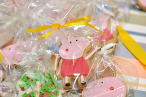 This image is showing one of the birthday party gift bag ideas which is a Peppa Pig themed decorated cookie.