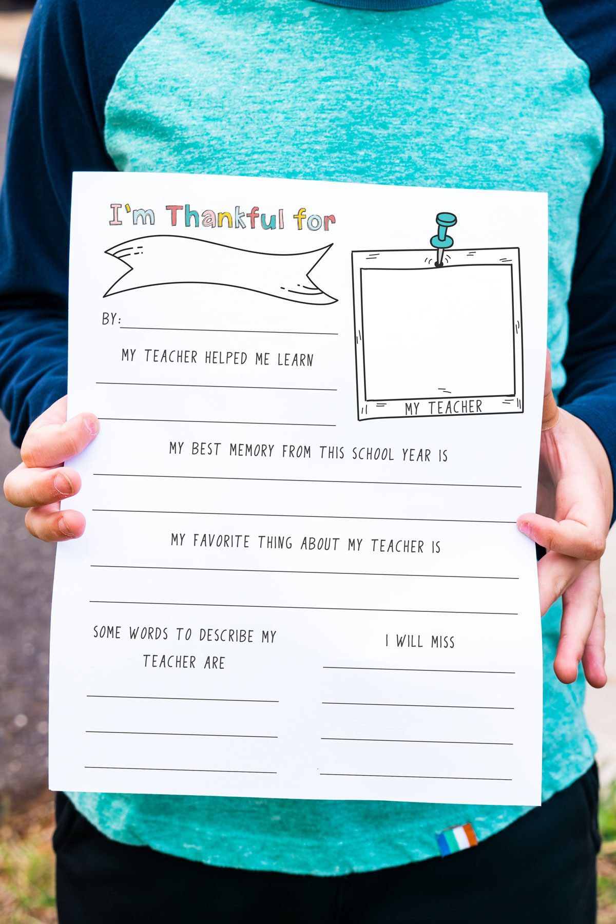 This image is of a child holding the free printable teacher appreciation questionnaire you can download at the end of this post. This is the black and white version.