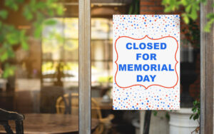 This image shows a free printable Closed for Memorial Day sign with the words surrounded by red and blue stars.