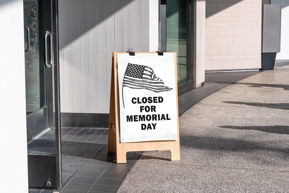 This image shows a free printable Closed for Memorial Day sign with a black and white American flag on the top left corner.