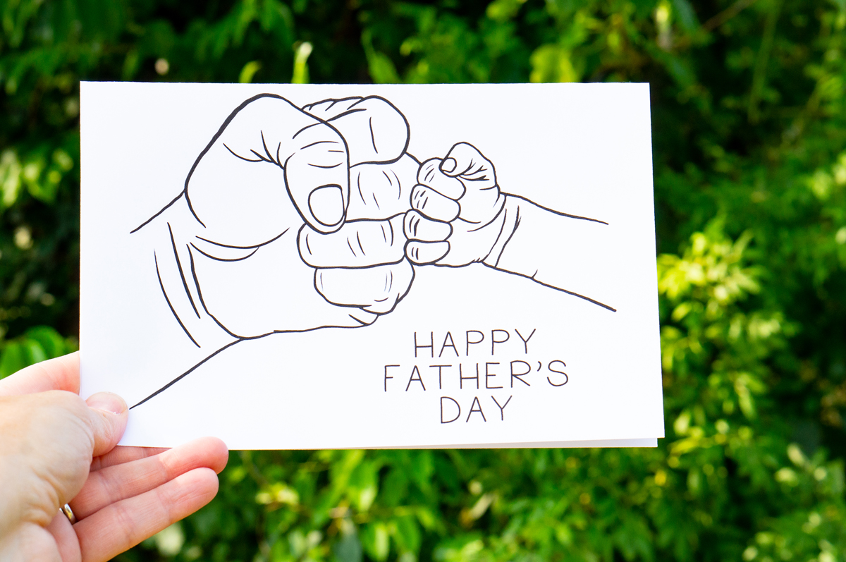 This card features a large hand fist pumping a small hand. It says Happy Father’s Day.