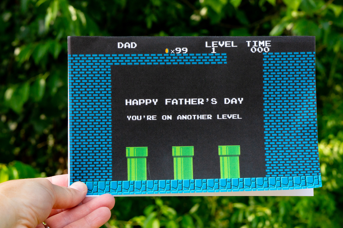 It shows a card that says, "Happy Father's Day You're on Another Level." The card is depicting a scene from a video game where you change levels.