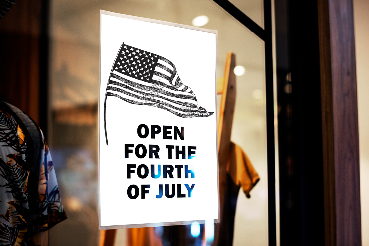 This shows a sign that says Open for the Fourth of July on a business' window. This is one of the printable Closed and Open for 4th of July templates you can download in this blog post.