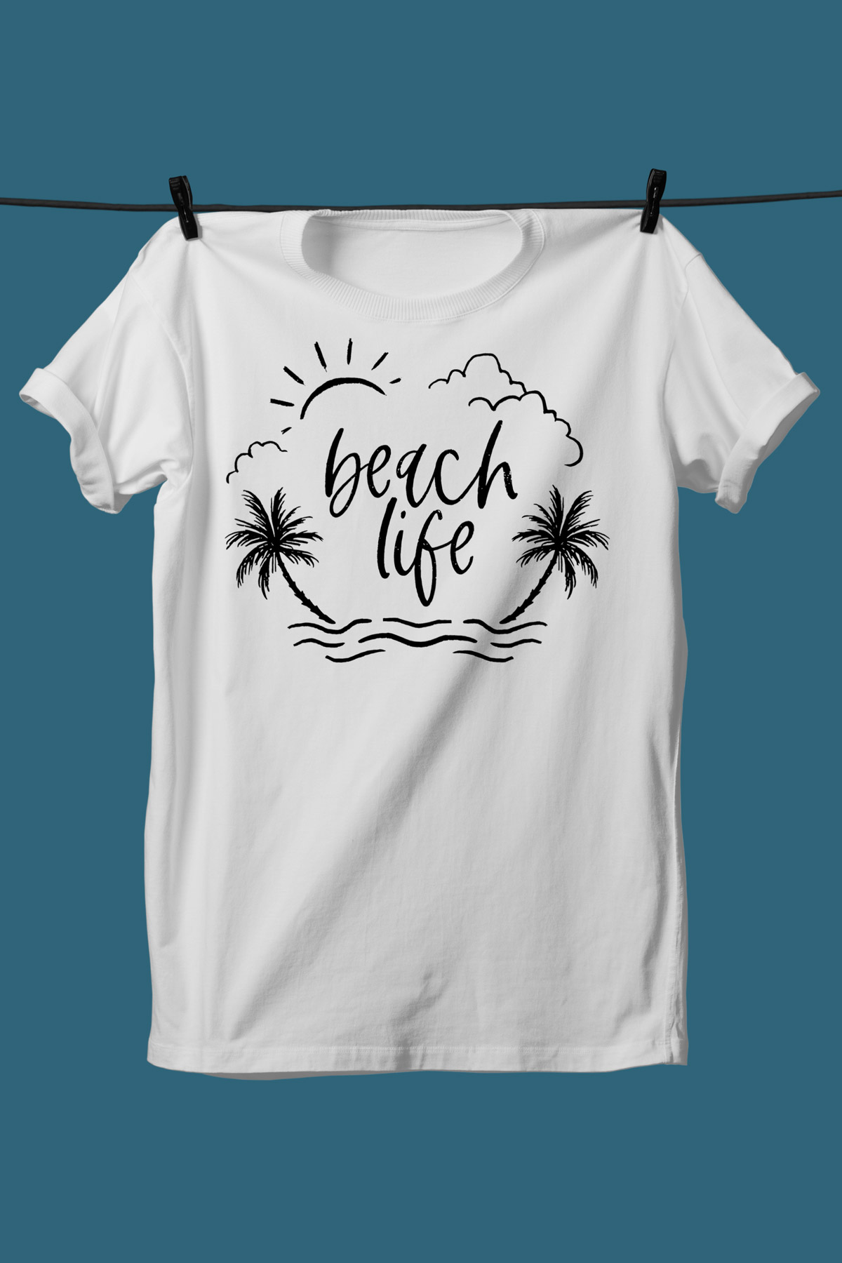 This image shows one of the SVGs from the free summer SVG set on a white tshirt. This one says beach life with the picture of waves, palm trees, clouds, and the sun.