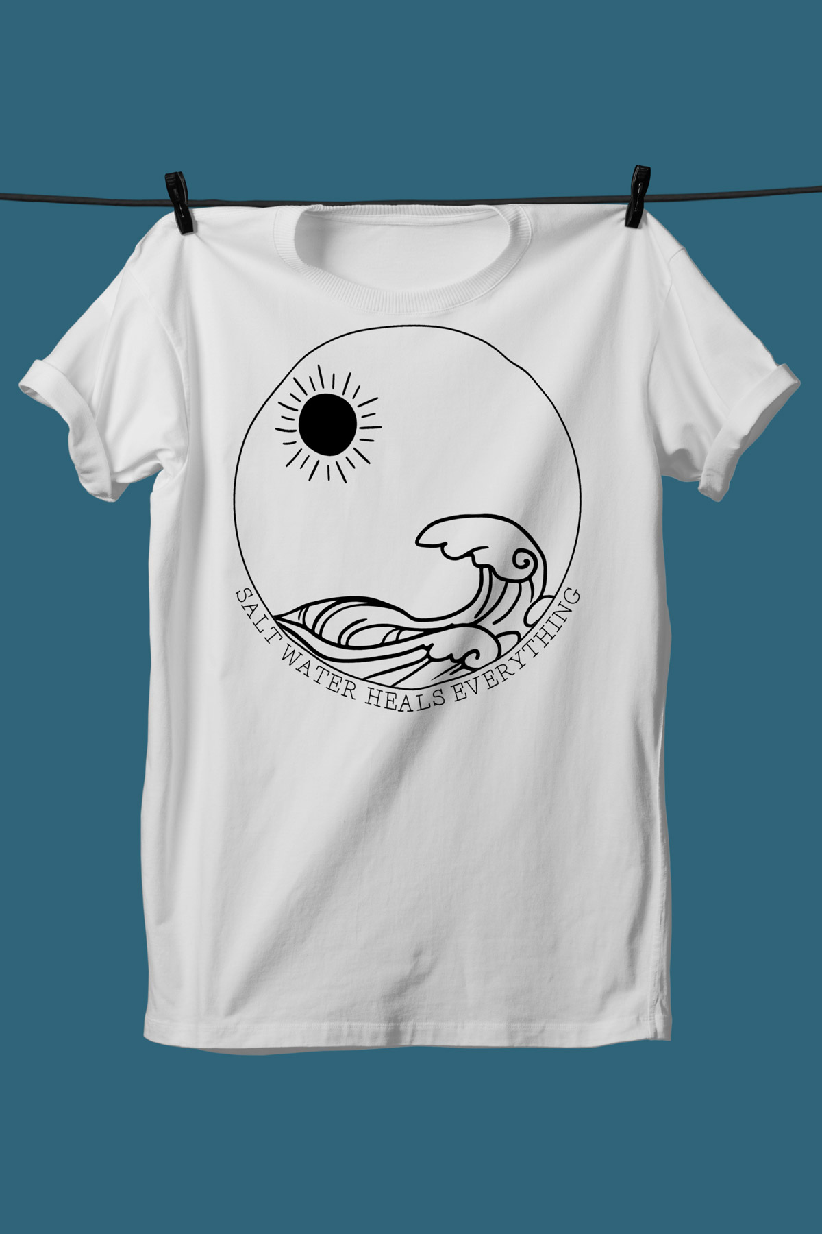 This image shows one of the SVGs from the free summer SVG set on a white tshirt. This one says salt water heals everything with the picture of waves and the sun.