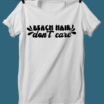 This image shows one of the SVGs from the free summer SVG set on a white tshirt. This one says beach hair don't care.