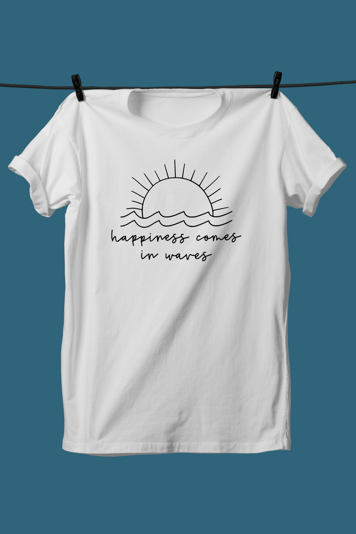 This image shows one of the SVGs from the free summer SVG set on a white tshirt. This one says happiness comes in waves with some waves and the sun.