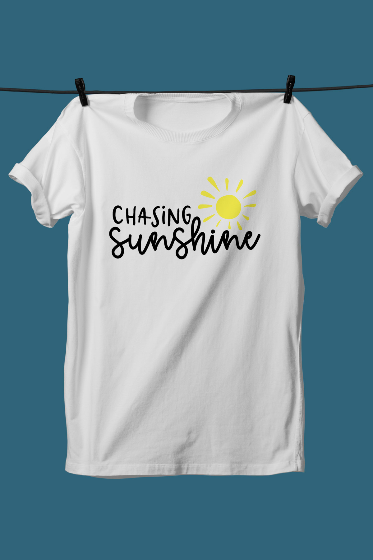 This image shows one of the SVGs from the free summer SVG set on a white tshirt. This one says chasing sunshine with a sun.