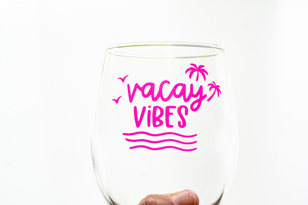 In this image, it shows one of the SVGs from the free summer SVG set. This one says vacay vibes and is on a wine glass.