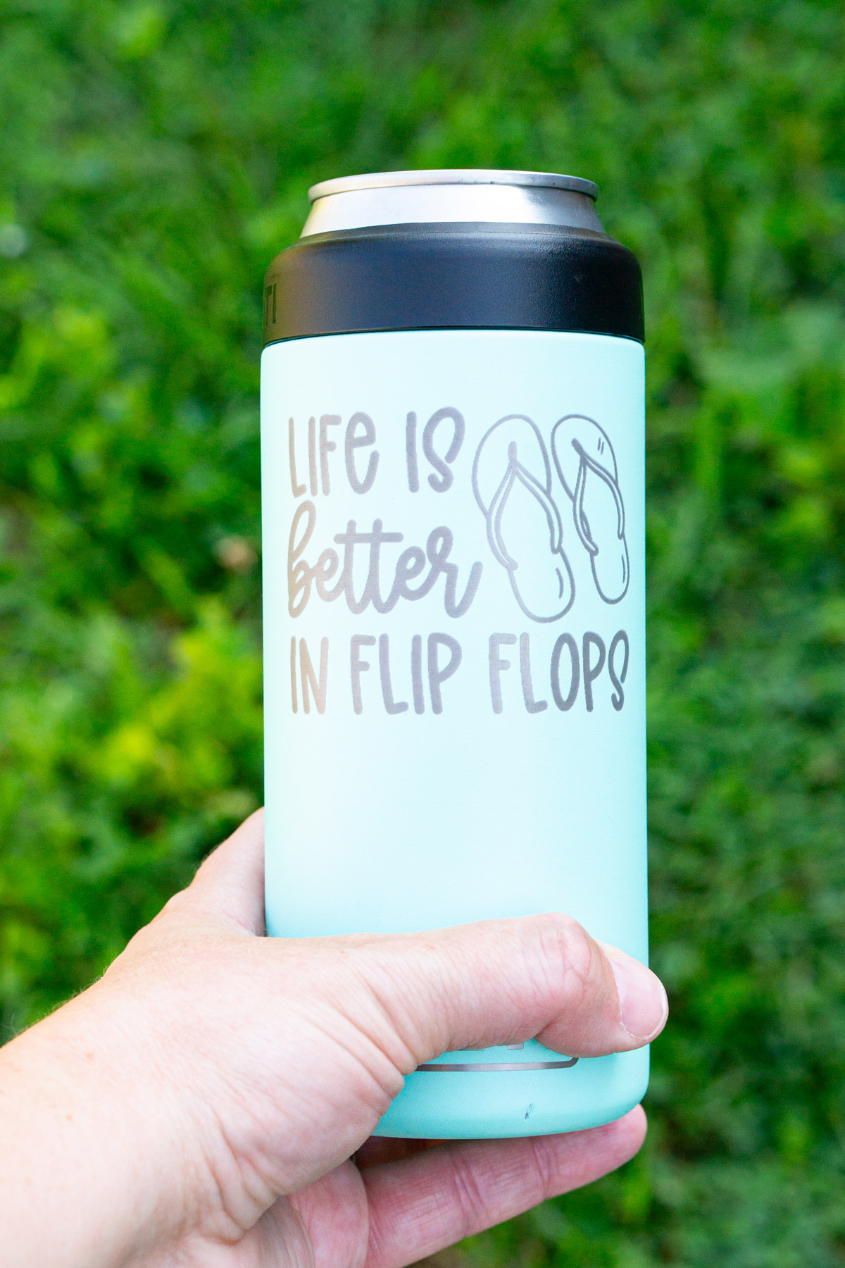 The image is of a laser engraved tumbler that says life is better in flip flops. Then there is an drawing of flip flops on the tumbler.