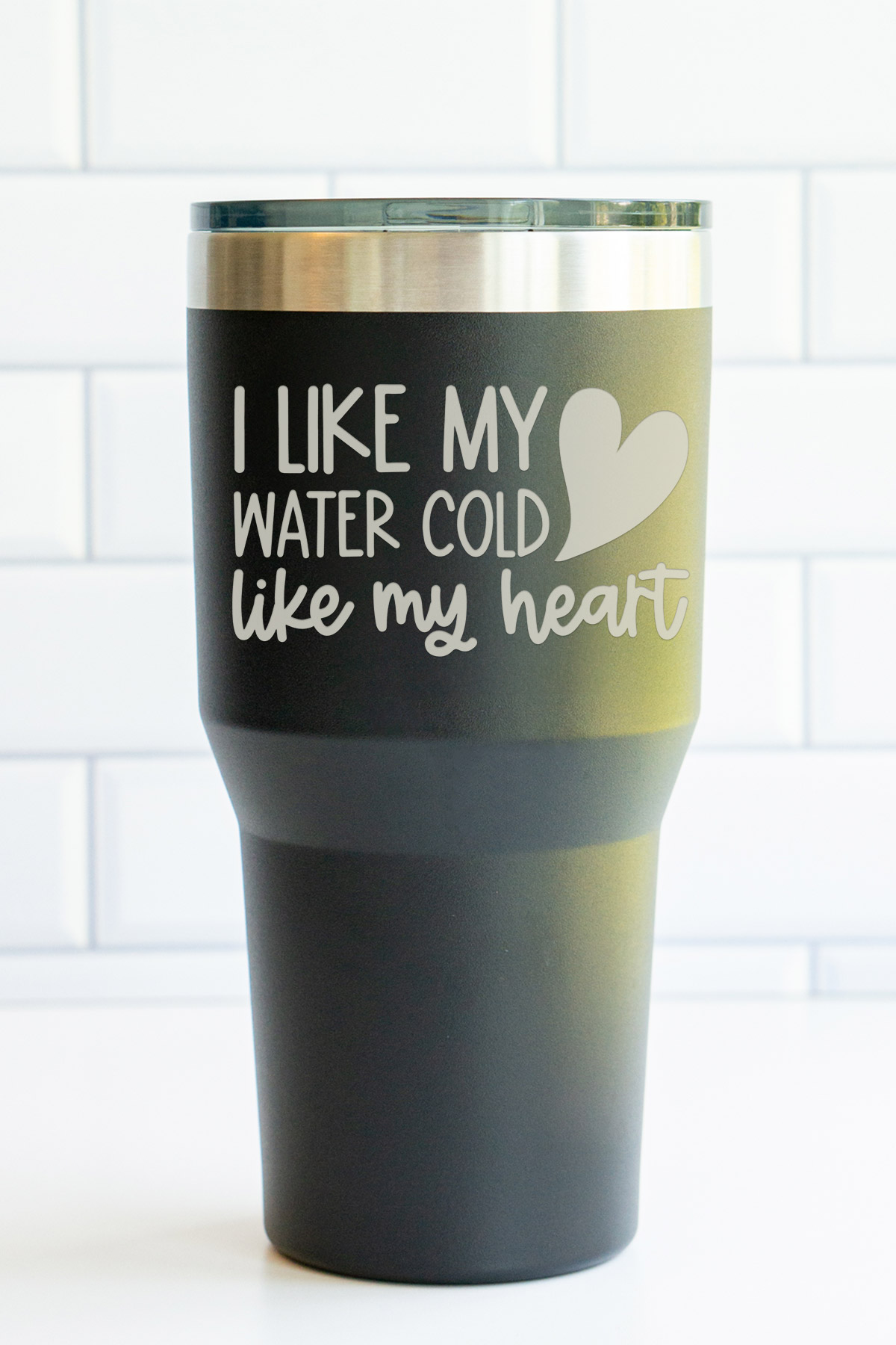 The image is of a laser engraved tumbler that says I like my water cold like my heart. It also has a small heart engraved on it.