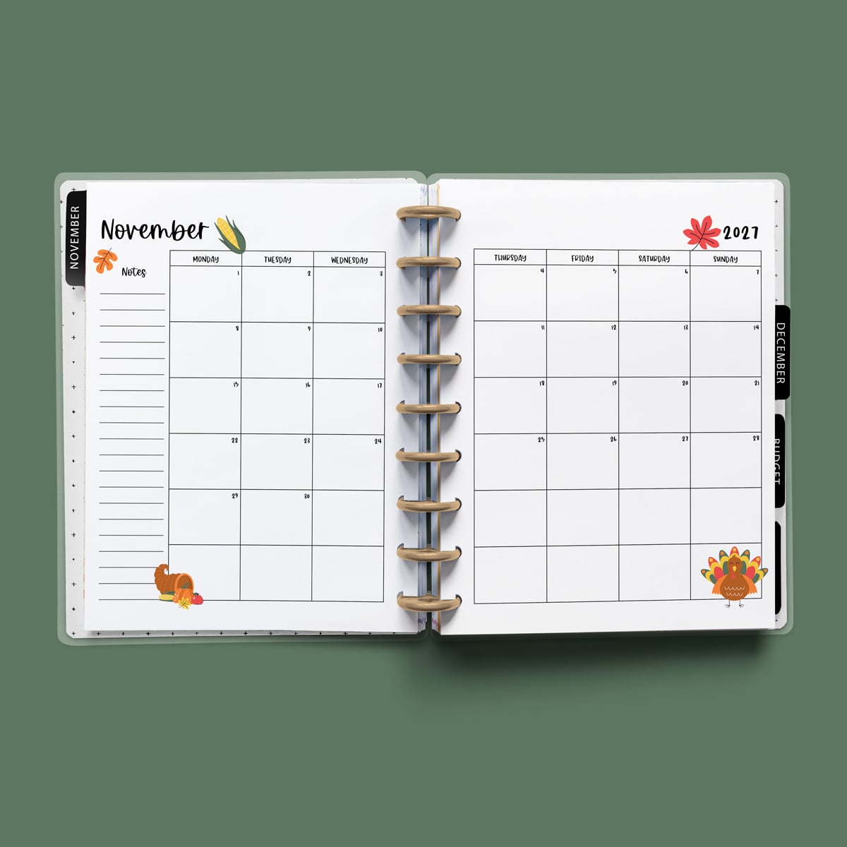 This image is an example of one of the printable 2027 calendar you can get for free at the end of this post. This is showing the month of November without holidays inside of an open planner.