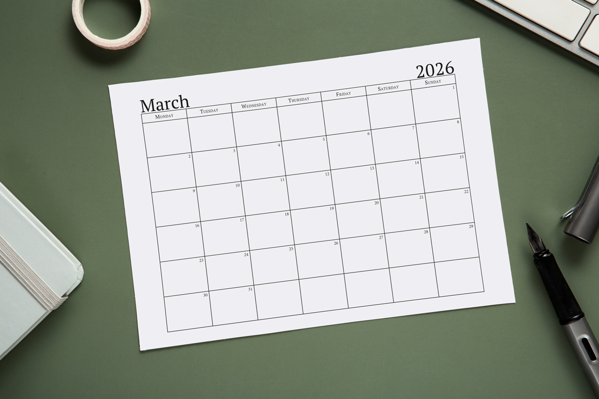 This image shows an example of the free 2026 calendar one page design you can get for free in this blog post. It's showing the month of March laying on a desk top.