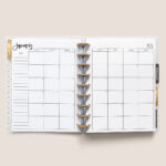 This image shows the free 2 page calendar template you can get at the end of this blog post. It's inside of an open planner to the month of January.