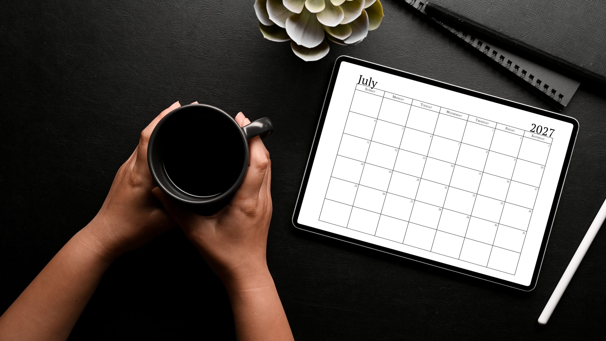 This image shows an example of the free 2027 calendar one page design you can get for free in this blog post. It's showing the month of July on a tablet screen.