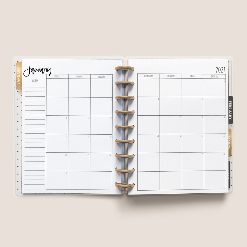 This image shows the free 2 page calendar template you can get at the end of this blog post. It's inside of an open planner to the month of January.