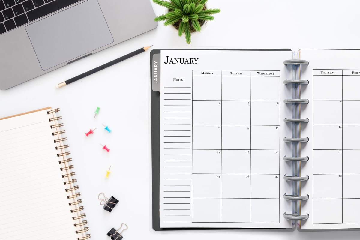 This image shows the 2027 free printable calendar you can download for free in this blog post. It is inside of an open planner on the month of January.