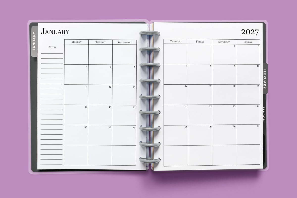 This image shows the 2027 free printable calendar you can download for free in this blog post. It is inside of an open planner on the month of January.