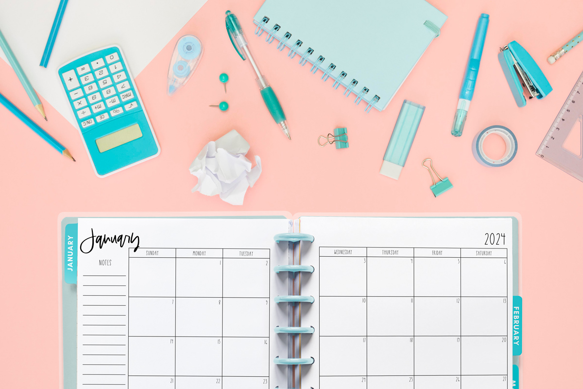 This image shows the free 2 page calendar template you can get at the end of this blog post. It's inside of an open planner to the month of January.