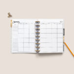 This image shows the free 2 page calendar template you can get at the end of this blog post. It's inside of an open planner to the month of January.