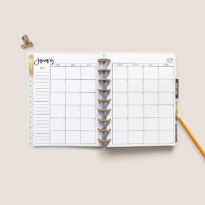 This image shows the free 2 page calendar template you can get at the end of this blog post. It's inside of an open planner to the month of January.