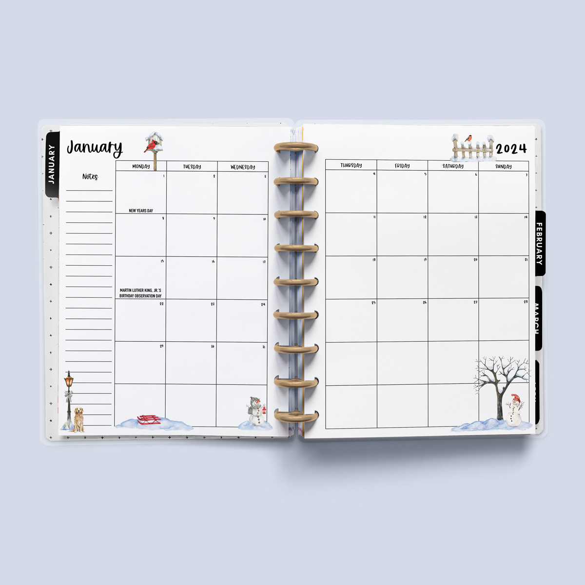 This image is an example of one of the printable 2024 calendar you can get for free at the end of this post. This is showing the month of January with holidays inside of an open planner.