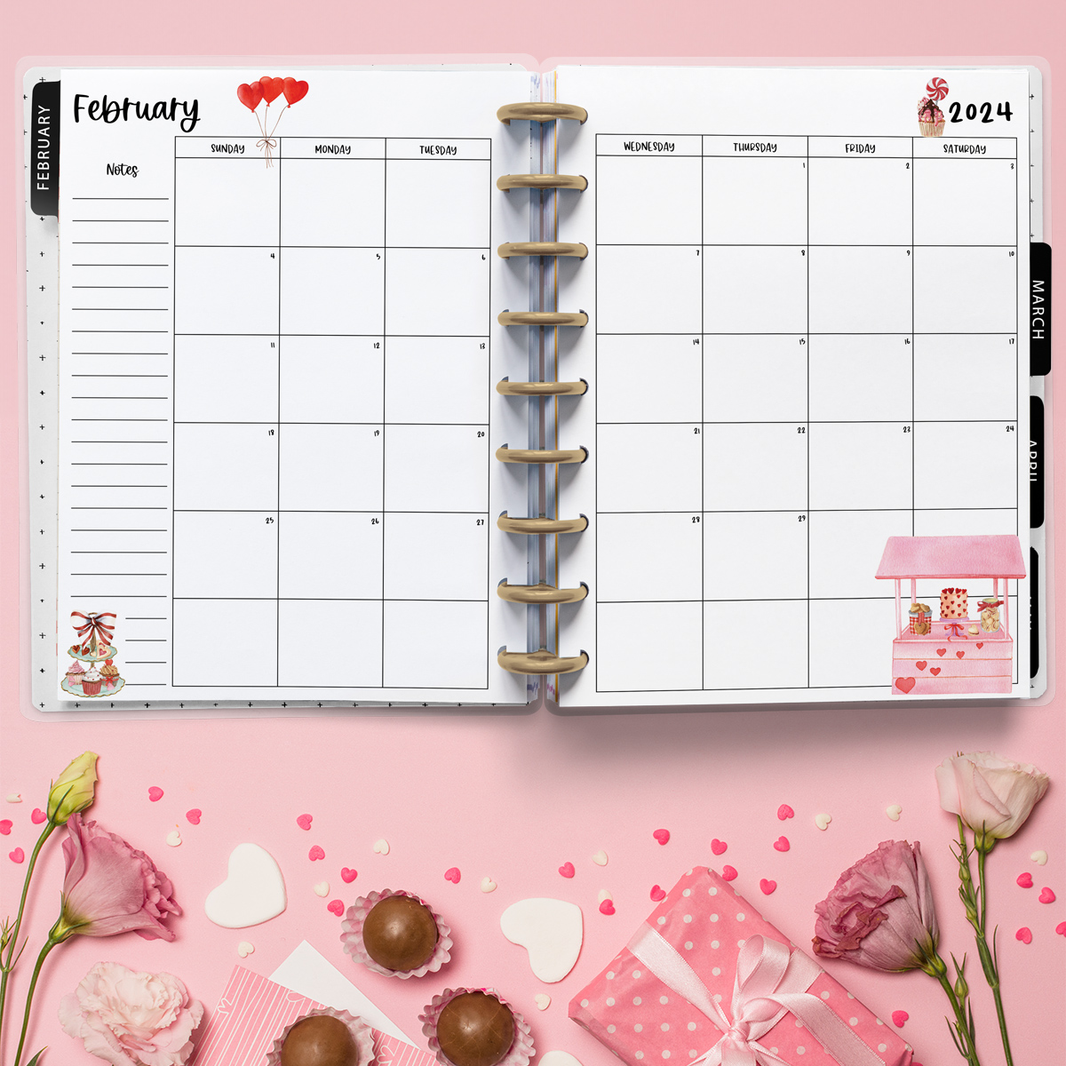 This image is an example of one of the printable 2024 calendar you can get for free at the end of this post. This is showing the month of February inside of an open planner. Below the planner is are some flowers, chocolates, and heart confetti.