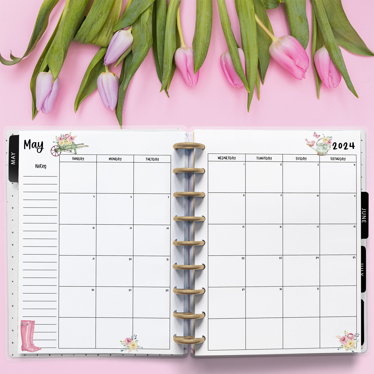 This image is an example of one of the printable 2024 calendar you can get for free at the end of this post. This is showing the month of May. Above the planner are some tulips.