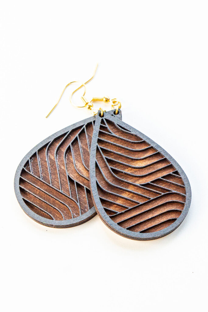 This is an image of a completed pair of wood earrings - tear drop graphic lines - made with an xTools M1 laser machine. Learn how to make the wood earring in the post.