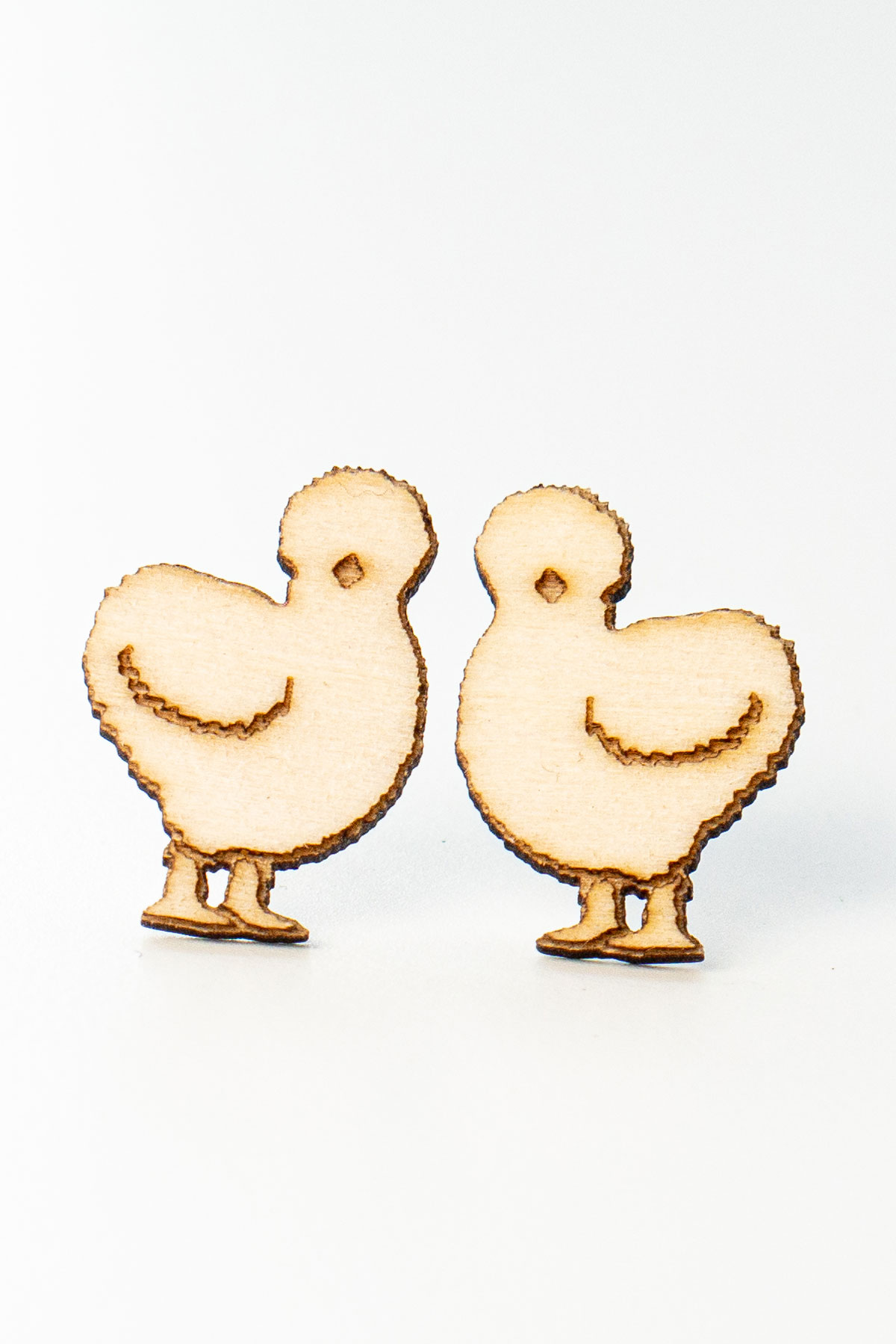 This is an image of a completed pair of wood earrings - silkie chickens - made with an xTools M1 laser machine. Learn how to make the wood earring in the post.