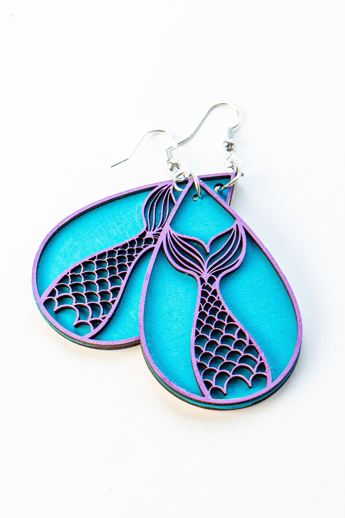 This is an image of a completed pair of wood earrings - tear drop mermaid tails - made with an xTools M1 laser machine. Learn how to make the wood earring in the post.