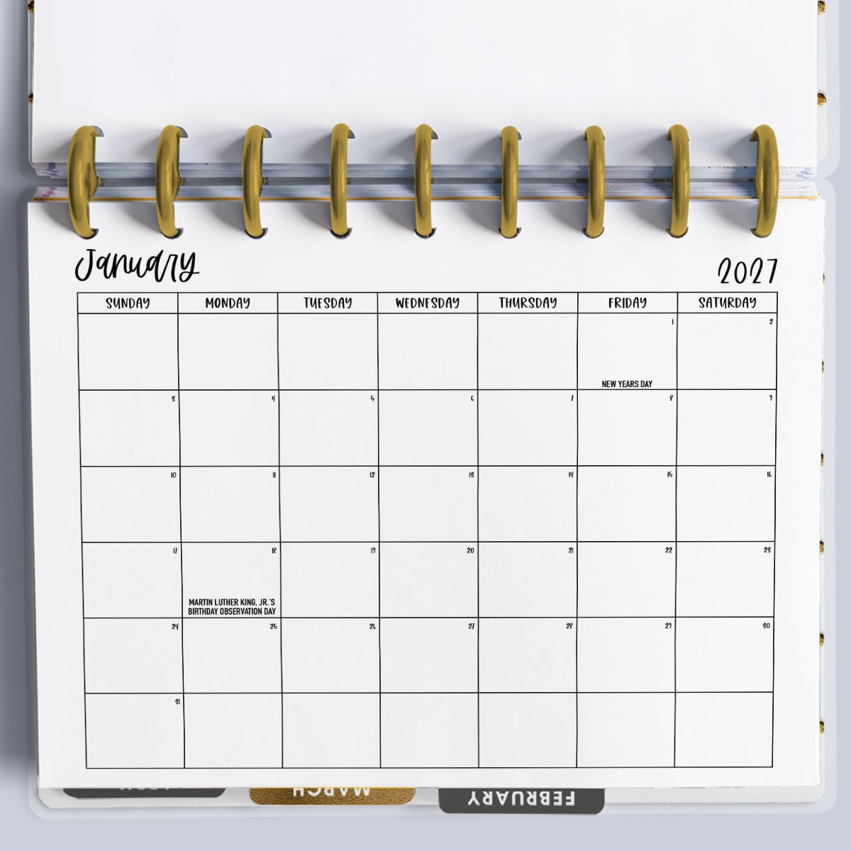 This image is showing a printable calendar starting with Sunday (but a Monday version is also available). It's inside of an open planner and is showing the month of January.