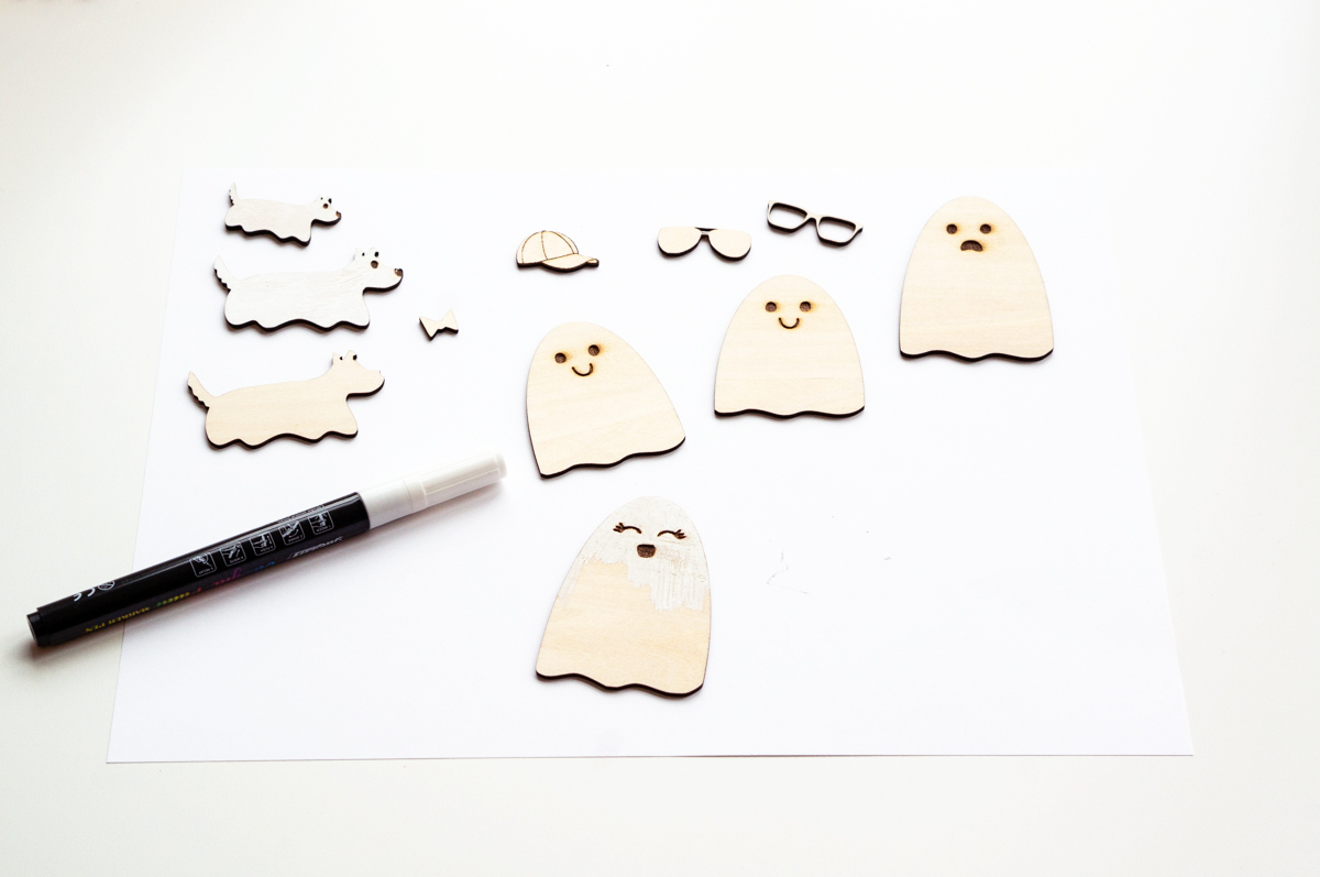 This image shows some of the wooden ghosts being painted white.