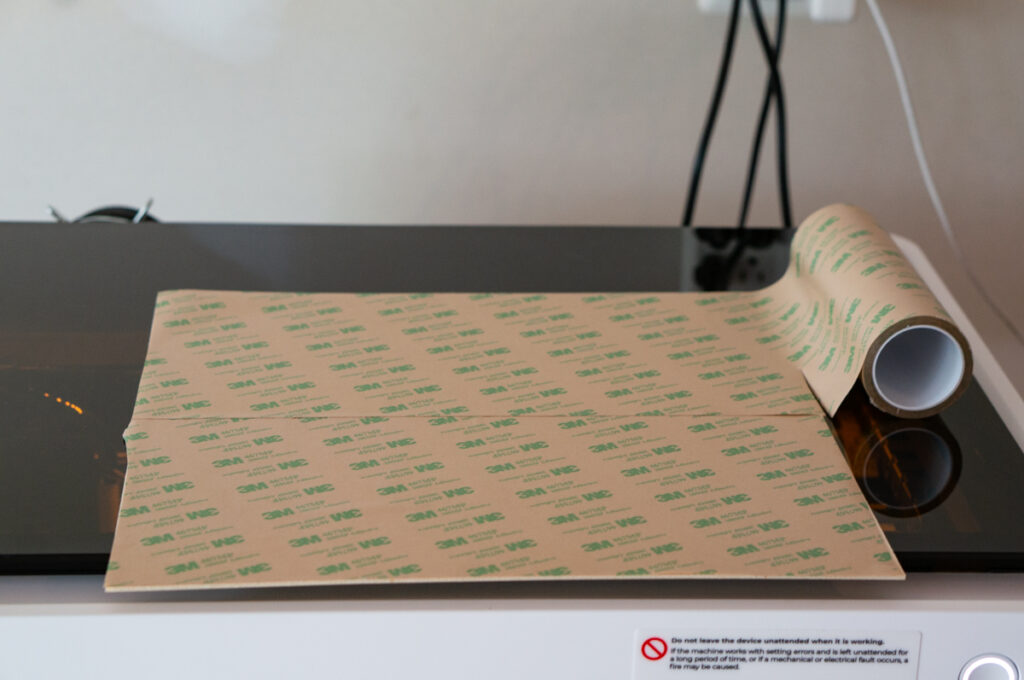 This image shows 3m adhesive backing placed on a wood sheet.