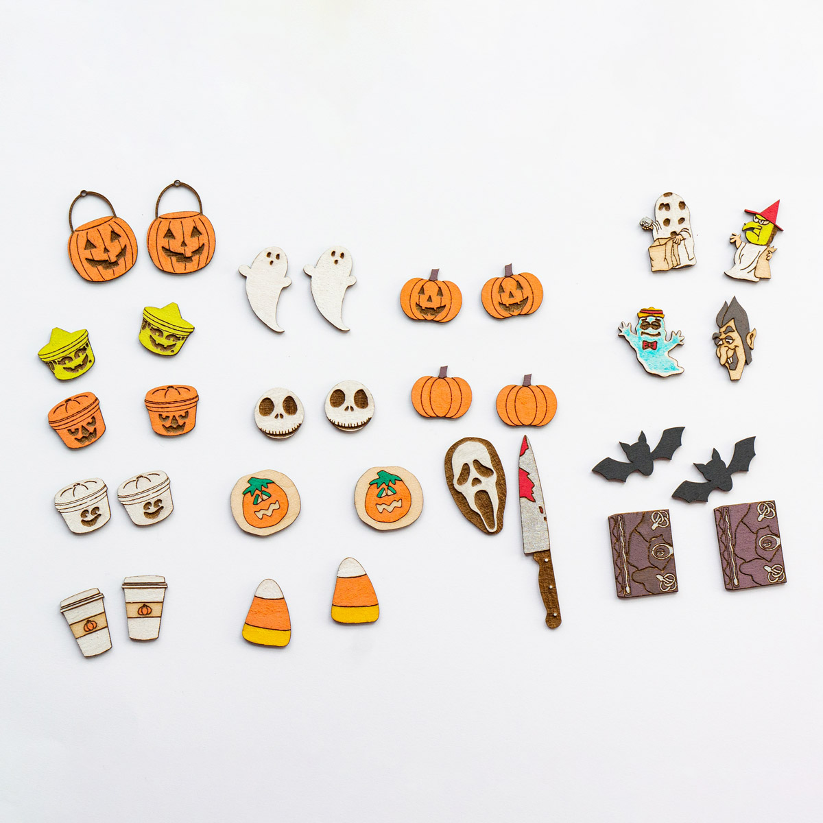 This image shows painted examples of the laser cut and engraved Halloween earrings using the free Halloween earring SVG set.