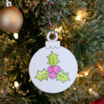 This image shows one of the free printable ornaments colored and cut out and hung on a Christmas tree.