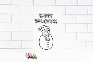 This is one of the 25 free printable Christmas cards to color you can get for free in this blog post. This one says Oh happy holidays.