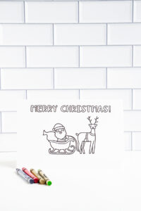 This is one of the 25 free printable Christmas cards to color you can get for free in this blog post. This one says Merry Christmas.