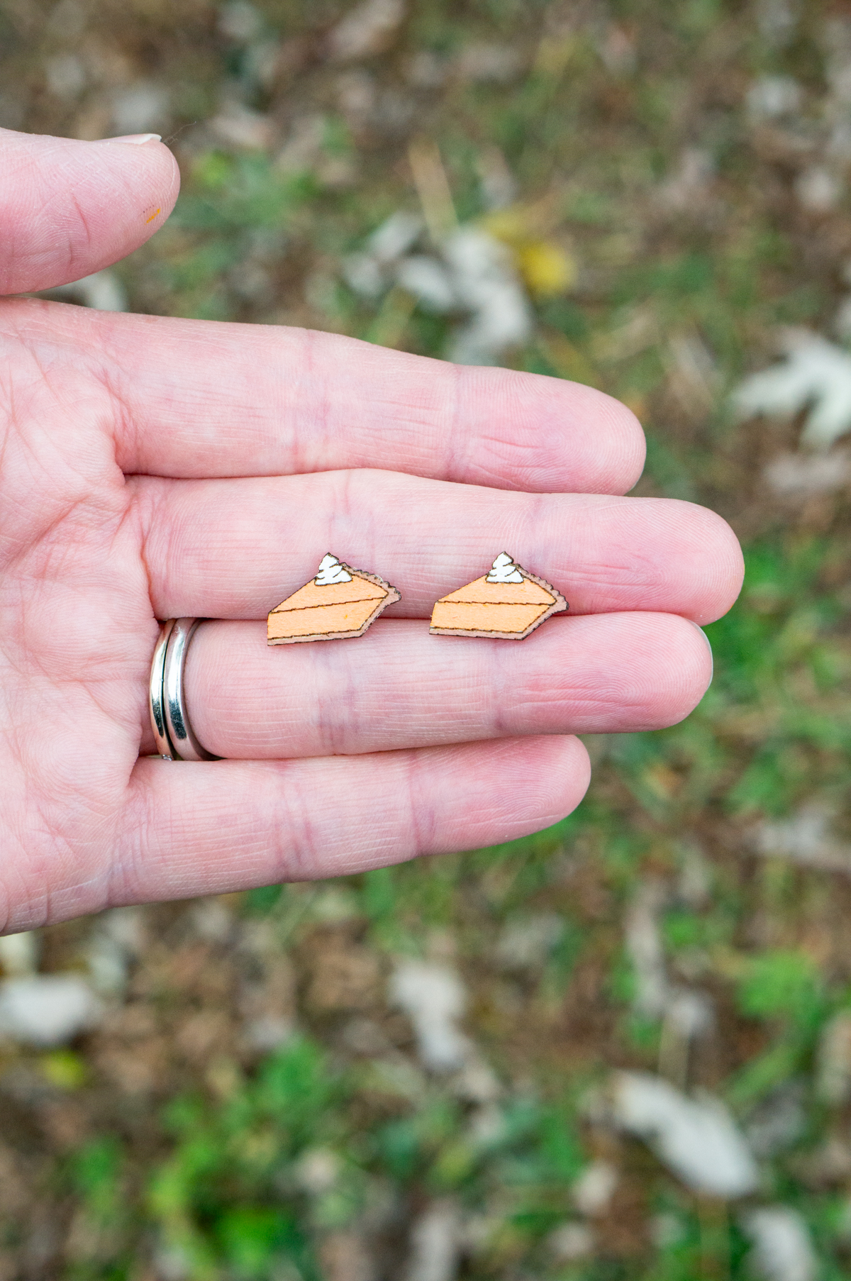 This shows the final slice of pumpkin pie earrings made using the free Thanksgiving earrings SVG files.