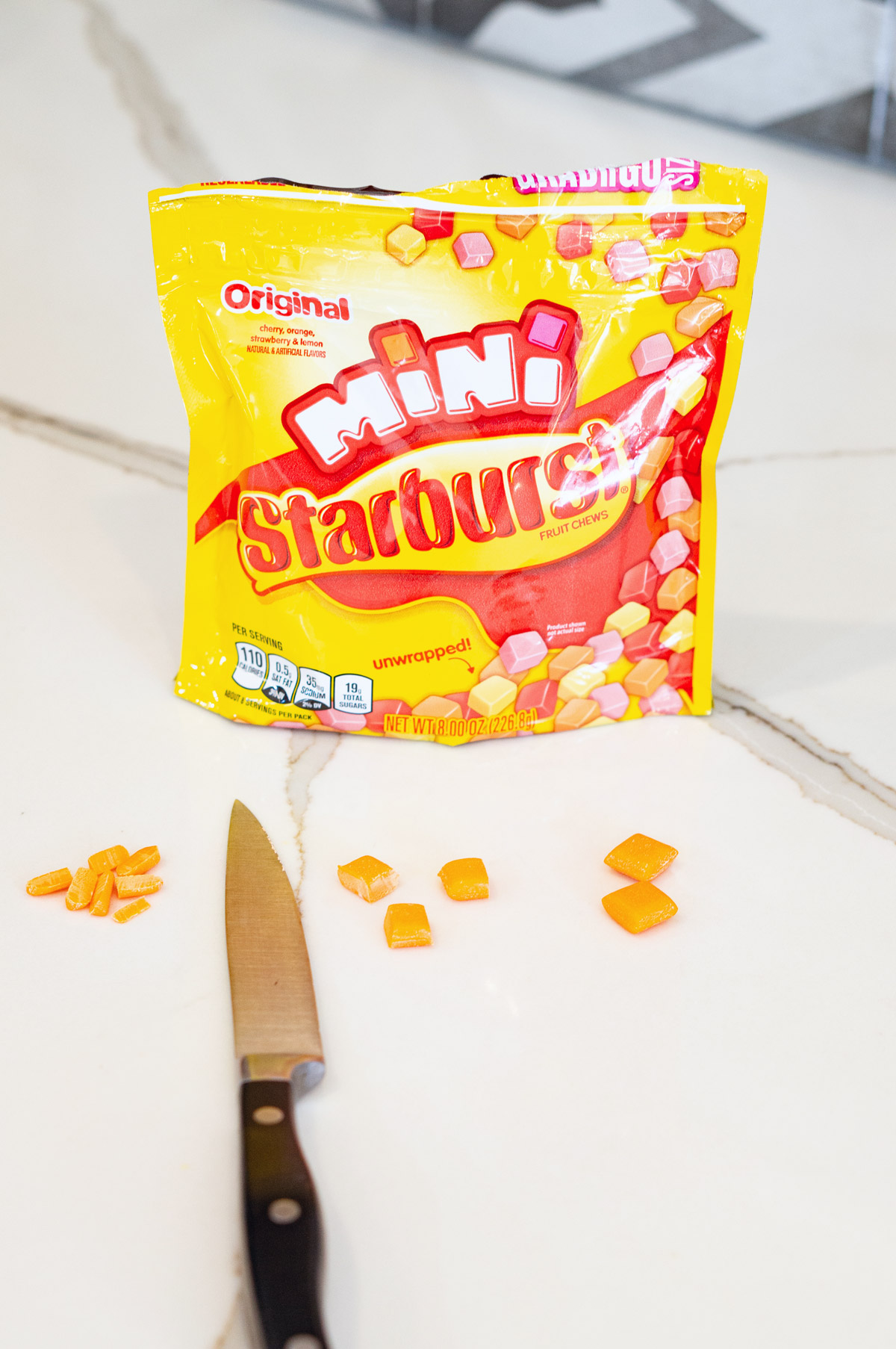 This image shows orange Startburst minis cut into tiny squares to make faux carrots.