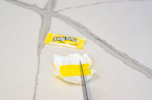 This image shows cutting out squares of taffy to go on the Turkey Dinner cookie sets.