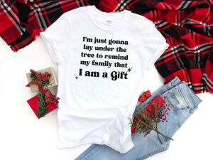 This is one of the free funny Christmas shirts you can make with the free SVGs from the post. This one says I'm just gonna lay under the tree to remind my family that I am a gift.