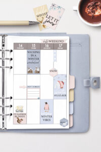 This is an image that is an open planner with some examples of the free winter stickers you can get in this post.