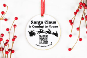 Learn how to make wooden ornaments with a laser using this adorable free Christmas Santa tracker ornament file. It says, "Santa Claus is coming to Town" and has a picture of Santa flying with his reindeer and a QR code to scan and visit the Santa tracker app.