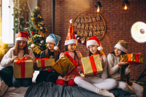This is an image of little girls lined up holding presents like they are playing along with the left right across Christmas game.