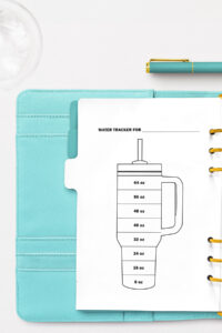 This image is an example of one of the water tracker printable options from the free printable water tracker set you can get for free in this blog post. It's next to two bottles of water.