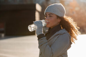 This is an image of a woman drinking a bottle of water.